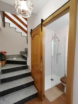 a bathroom with a shower and a glass door at Casa Carreira Bierzo in Ponferrada