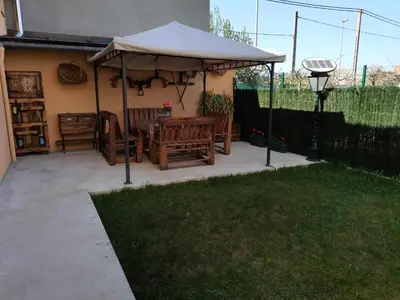 a patio with an umbrella and a table and chairs at Casa Carreira Bierzo in Ponferrada
