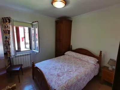 a bedroom with a bed and a window at Casa Carreira Bierzo in Ponferrada