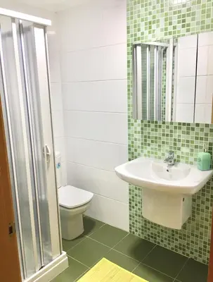 a bathroom with a sink and a toilet at Piso céntrico próximo a la playa in Burela de Cabo