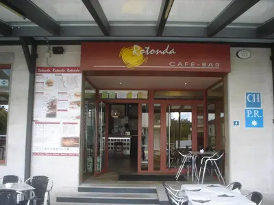 a cafe bar with tables and chairs in front of it at HOSTAL CID in Ourense