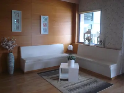 a living room with a white couch and a window at HOSTAL CID in Ourense