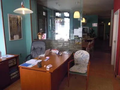 an office with a desk and a chair with a laptop at Albergue O Durmiñento in Sarria