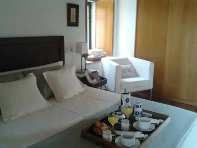 a living room with a bed with a tray of food at Torres de Moreda in A Estrada