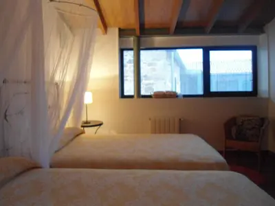 a bedroom with a bed and a window at Torres de Moreda in A Estrada