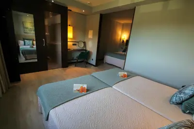 a hotel room with a bed with flowers on it at Hotel Torre de Núñez in Lugo
