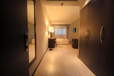 a hallway of a hotel room with a bed at Hotel Torre de Núñez in Lugo
