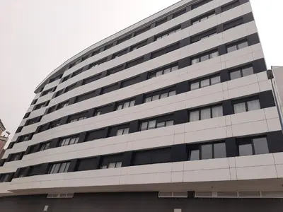 a large office building with a lot of windows at Precioso apartamento in Lugo
