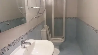 a bathroom with a toilet and a sink and a shower at Precioso apartamento in Lugo