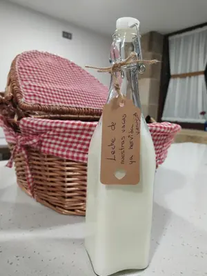 a bottle with a tag on it next to a basket at REMANSO DE TRASFONTAO Casa das Árbores & Bubble in Silleda