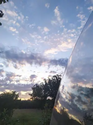 a reflection of a cloudy sky in a car window at REMANSO DE TRASFONTAO Casa das Árbores & Bubble in Silleda