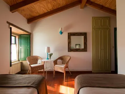 a bedroom with two beds and a table and chairs at Casa Blanco in Palas de Rei