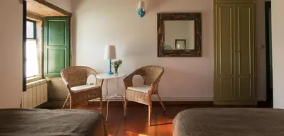 a room with two chairs and a table with a mirror at Casa Blanco in Palas de Rei