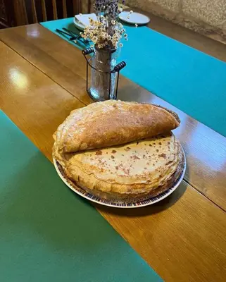 two large breads sitting on top of a table at Casa Blanco in Palas de Rei