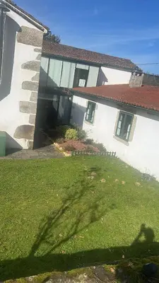 a large white house with a grass yard at Casa Blanco in Palas de Rei