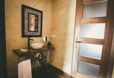 a bedroom with a bed with white sheets and pillows at Hotel Rural La Guaja in Puebla de Sanabria