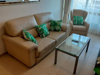 a living room with a couch and a glass table at L&L Livin & Live in Arzúa