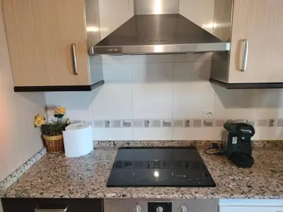 a kitchen with a stove top oven in a kitchen at L&L Livin & Live in Arzúa