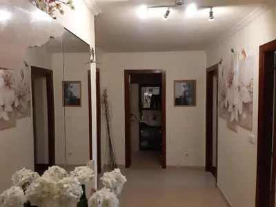a room with white flowers and a mirror at L&L Livin & Live in Arzúa