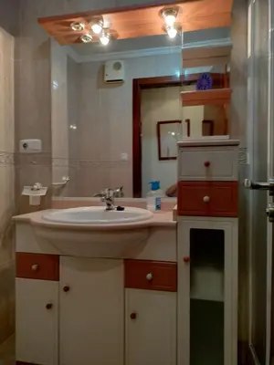 a bathroom with a sink and a mirror at L&L Livin & Live in Arzúa