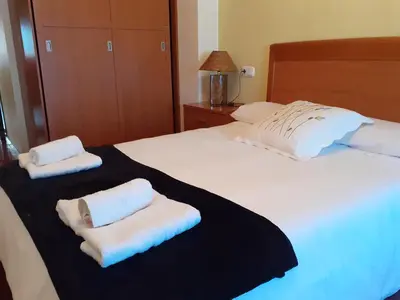 a bedroom with two beds with towels on them at L&L Livin & Live in Arzúa