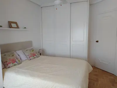 a white bedroom with a bed with two pillows at Casa FR VUT-OR-0345 in Ourense