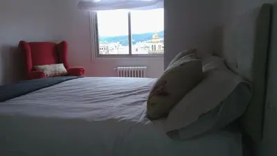 a bedroom with a white bed with a window at Casa FR VUT-OR-0345 in Ourense