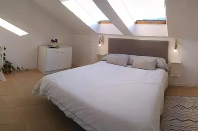 a bedroom with a large white bed with two pillows at Casa FR VUT-OR-0345 in Ourense