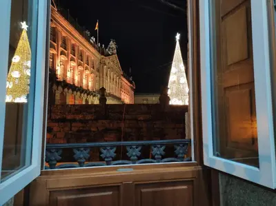 a window view of a building with a christmas tree at Apartamento con vistas a la catedral in Santiago de Compostela
