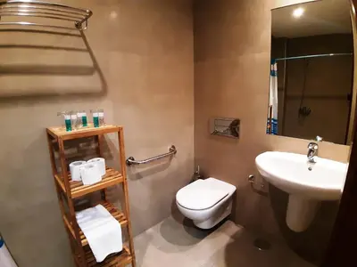 a bathroom with a toilet and a sink at Hostal Nirvana in Ponferrada
