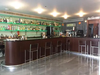 a bar at a restaurant with stools at Hostal Nirvana in Ponferrada