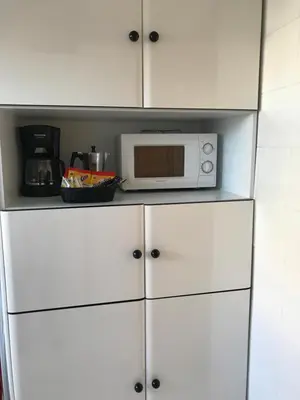 a microwave sitting on top of a white kitchen cabinets at VUT-OR-182 Atico Emilia Pardo Bazán in Allariz