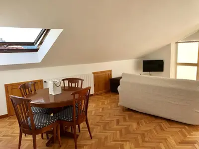 a living room with a table and a couch at VUT-OR-182 Atico Emilia Pardo Bazán in Allariz