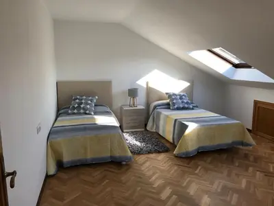 a bedroom with two beds in a attic at VUT-OR-182 Atico Emilia Pardo Bazán in Allariz