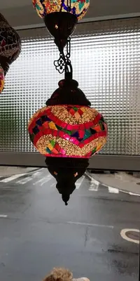 a colorful chandelier hanging from a window at Elena in Arzúa