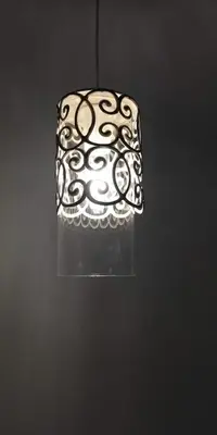 a black and white lamp hanging from a wall at Elena in Arzúa
