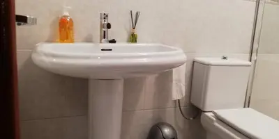 a bathroom with a white sink and a toilet at Elena in Arzúa
