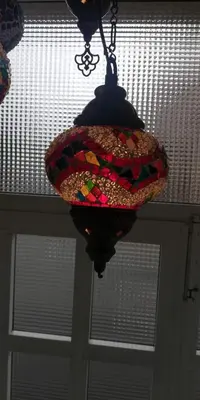 a stained glass chandelier hanging from a ceiling at Elena in Arzúa