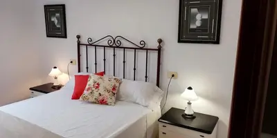 a bedroom with a bed with two night stands and two lamps at Elena in Arzúa