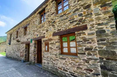a stone building with windows on the side of it at Casas da Lexa in Taramundi