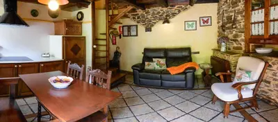 a living room with a couch and a table at Casas da Lexa in Taramundi