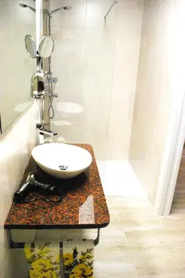 a bathroom with a sink on a counter with a mirror at Hotel Vilaseco in Chantada