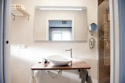 a bathroom with a sink and a mirror at Hotel Vilaseco in Chantada