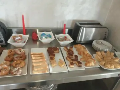a table topped with different types of donuts and pastries at Hotel Vilaseco in Chantada