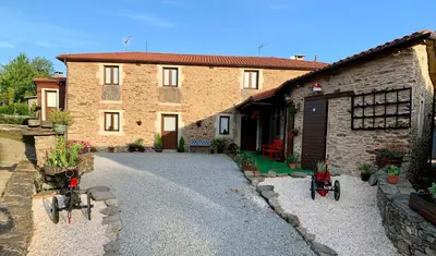 a building with two bikes parked in front of it at Casa do Horreo in O Pino