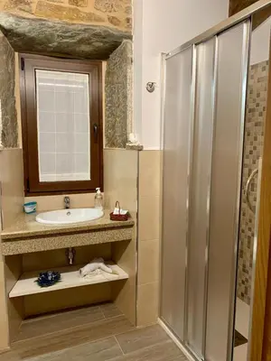 a bathroom with a sink and a shower at Casa do Horreo in O Pino