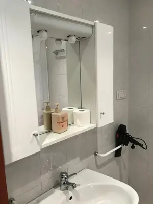a bathroom with a sink and a mirror at vivienda vacacional Iguazu in Ribadeo