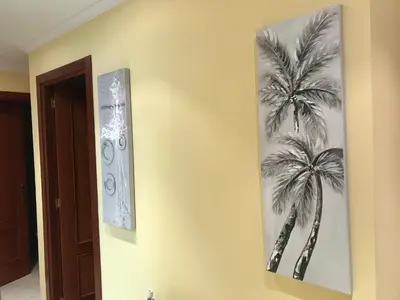 a picture of a palm tree on a wall at vivienda vacacional Iguazu in Ribadeo