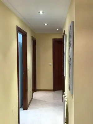 a hallway with two doors and a tile floor at vivienda vacacional Iguazu in Ribadeo
