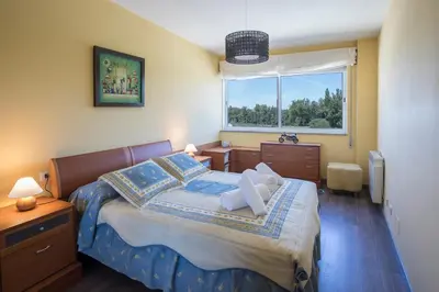 a bedroom with a bed and a window at JacobeAndo in Sarria